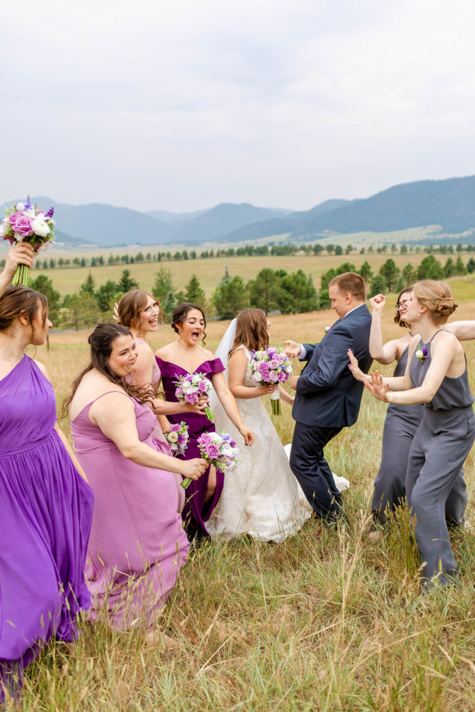 Spruce Mountain Ranch Wedding | Indy Pop Photography | Colorado Wedding Photographer | Colorado wedding inspiration, wedding party photos, purple bridesmaids dresses, mismatched bridesmaid dresses, fun wedding party, bridal party, dance party | via indypopphoto.com