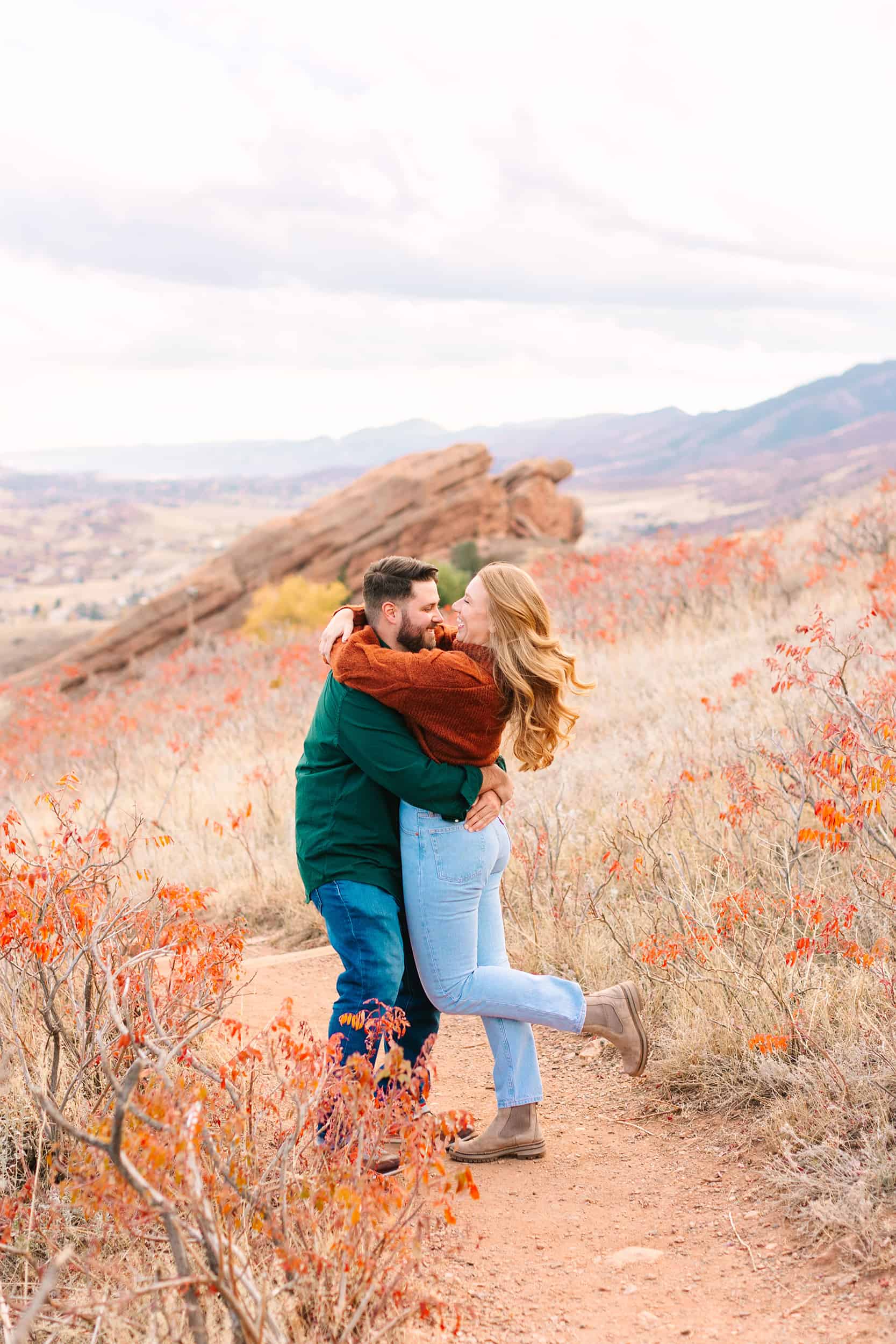 energetic engagement session at red rocks park in colorado
