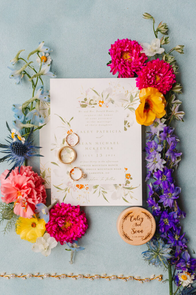 Wedding Invitation flat lay details with colorful flowers by Lil Bug Floral