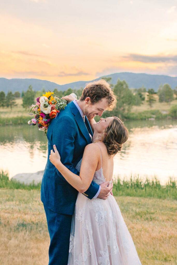 Bride and groom embracing each other during sunset at spruce mountain ranch